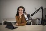 Woman in front of a podcast mic
