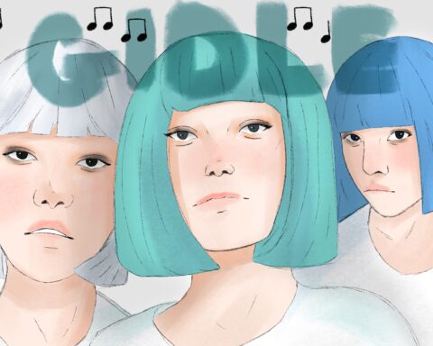 Three women in white t-shirts and colored bob cuts -- left to right: white, blue-green and blue -- stare blankly at the front. They are standing against a white background, the phrase "GIDLE" spelled out above their heads in a graffiti-like texture, as musical notes dot the screen.