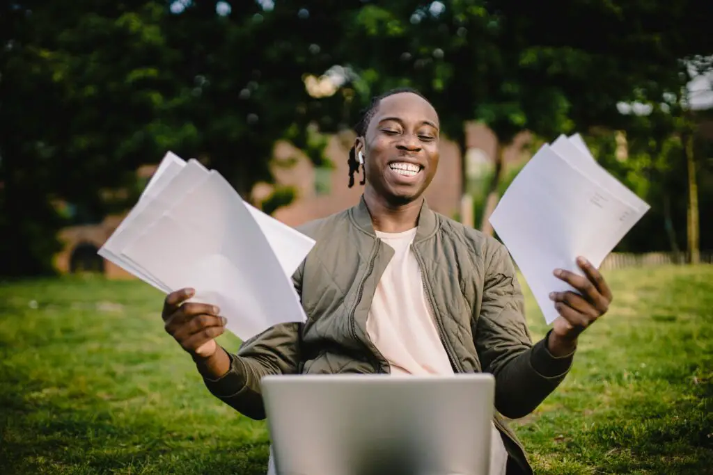 Man sitting in front of laptop with papers. 