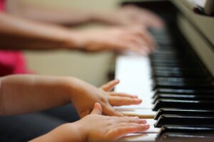 Childs finger on piano.