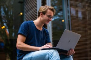 man sitting in front of a laptop