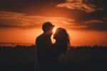 Man and woman hugging at sunset