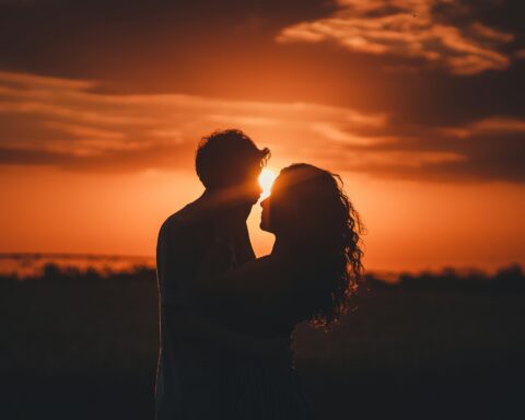 Man and woman hugging at sunset