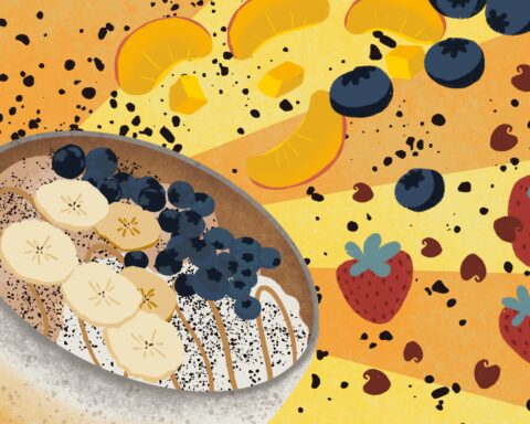 A white bowl of food dusted with grey sits in front of an orange-and-yellow striped background. It contains substances of various colors: white, brown, clay-esque in tone, a caramel stripe running through the center. Bananas and blueberries top it, whilst other fruits such as strawberries, more blueberries and peaches explode across the back ground, black flecks flying with them.